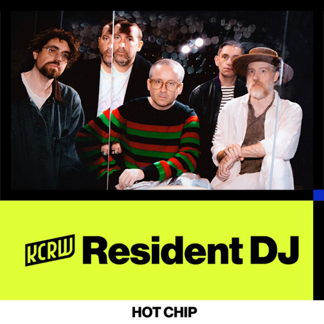 Five-member music group Hot Chip posing together against dark background with KCRW Resident DJ logo on bright yellow banner.