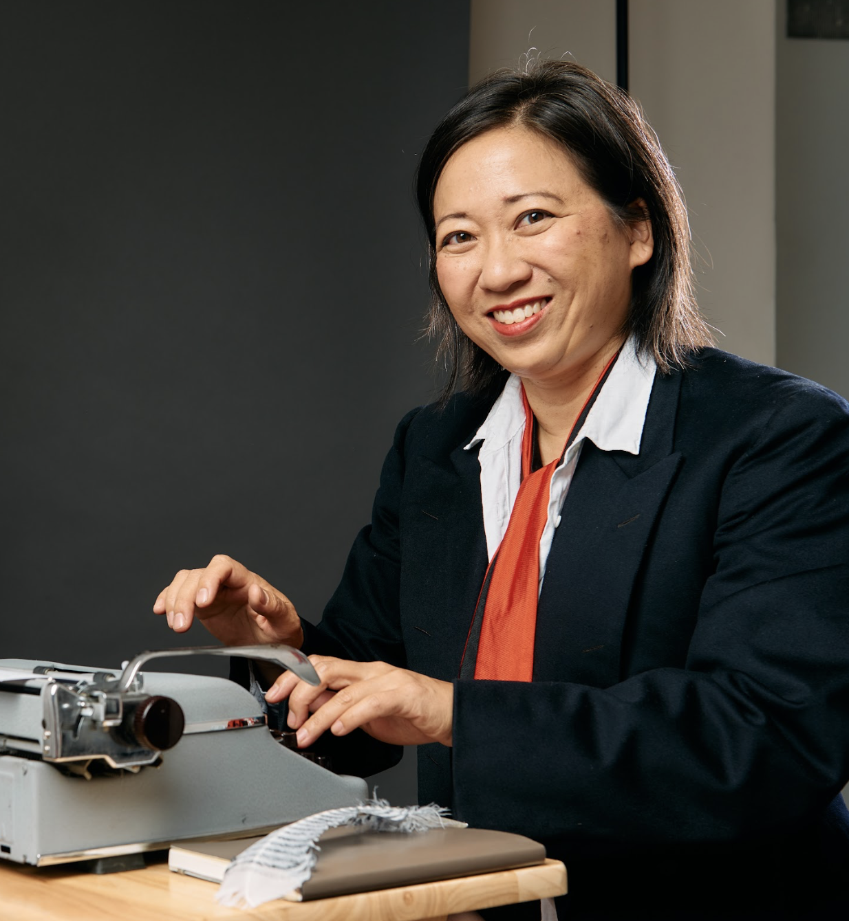 Jen Cheng, the city of West Hollywood's Poet Laureate, sits at a typewriter. 