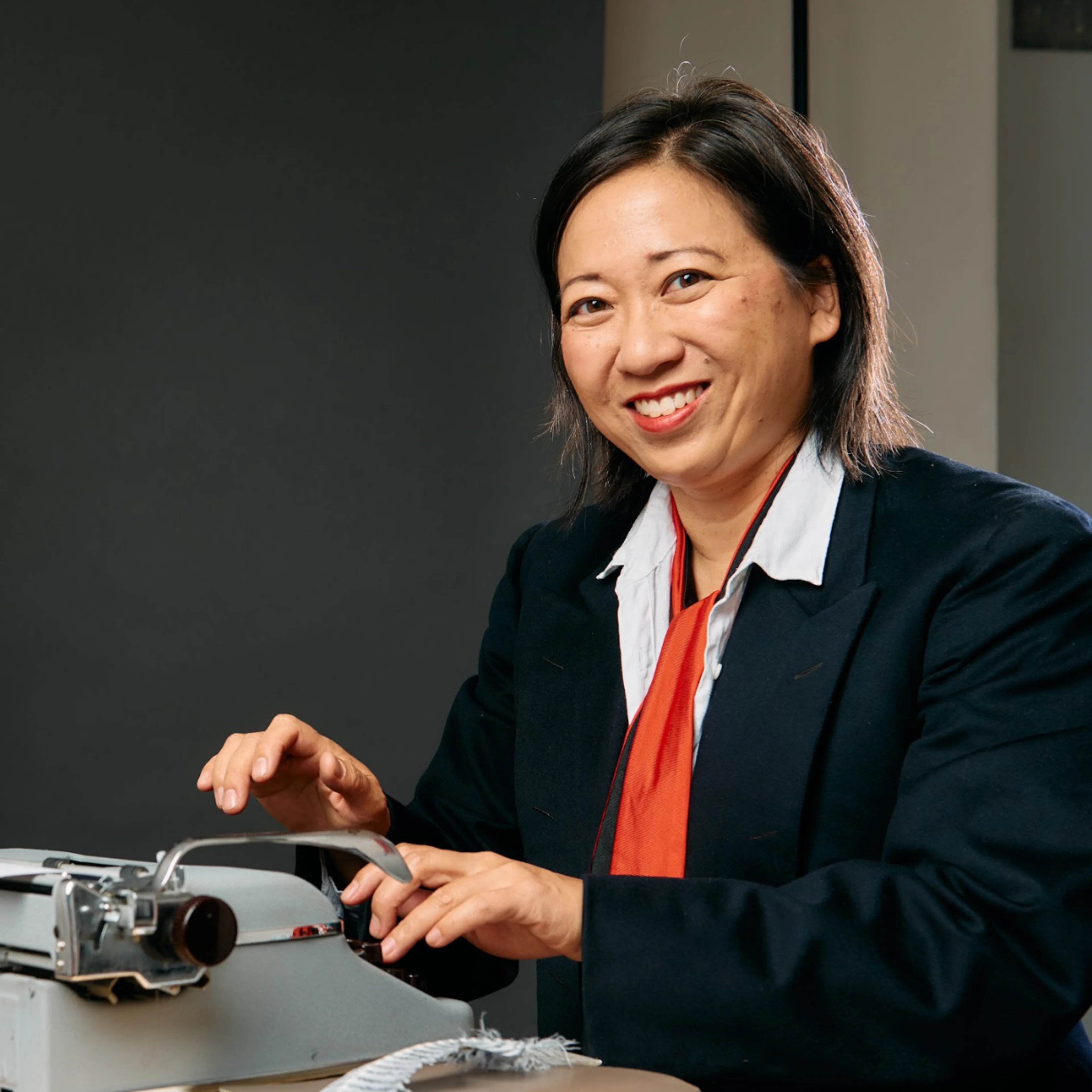 Jen Cheng, the city of West Hollywood's Poet Laureate, sits at a typewriter.