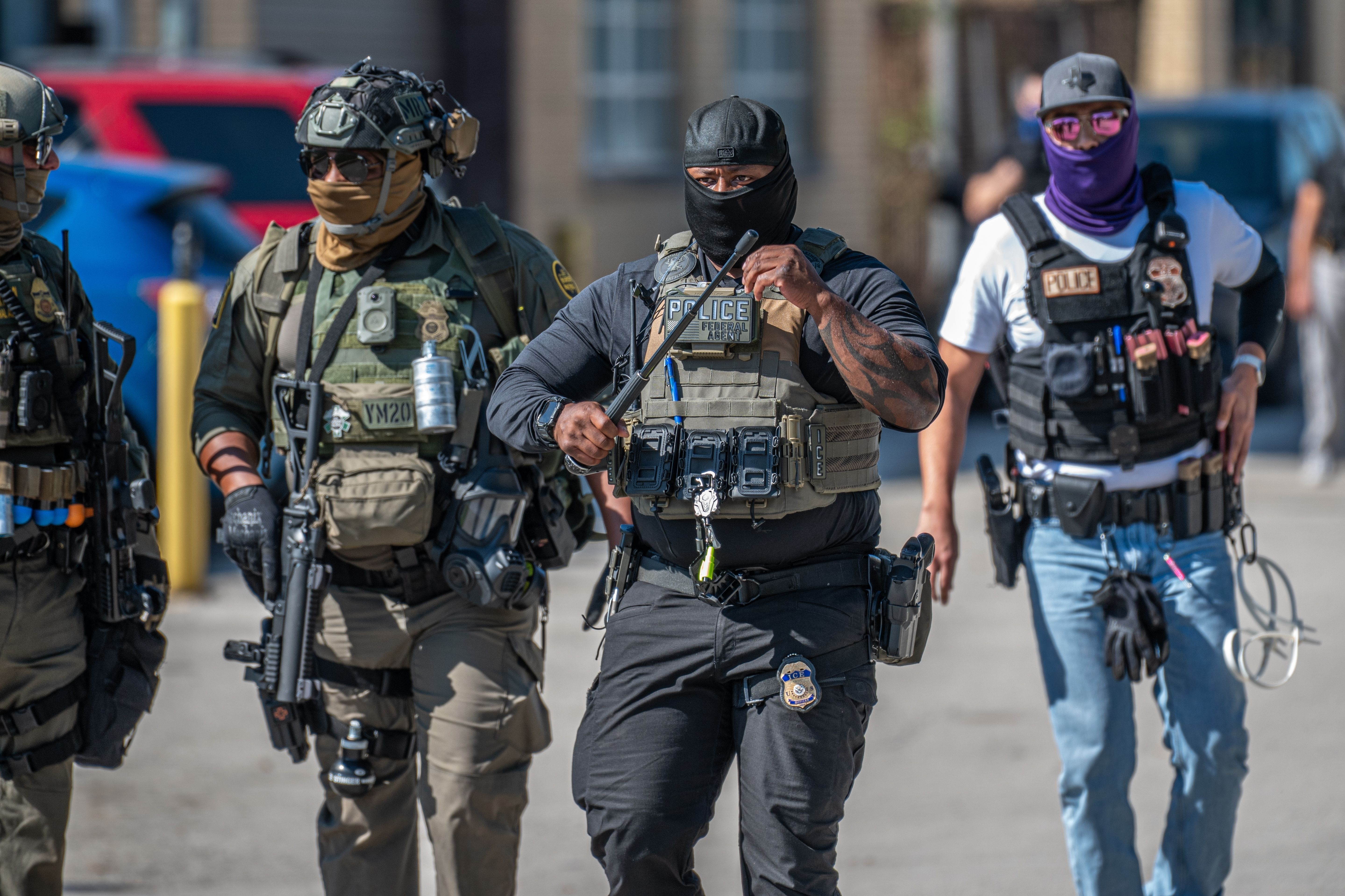 Three men in police gear walking