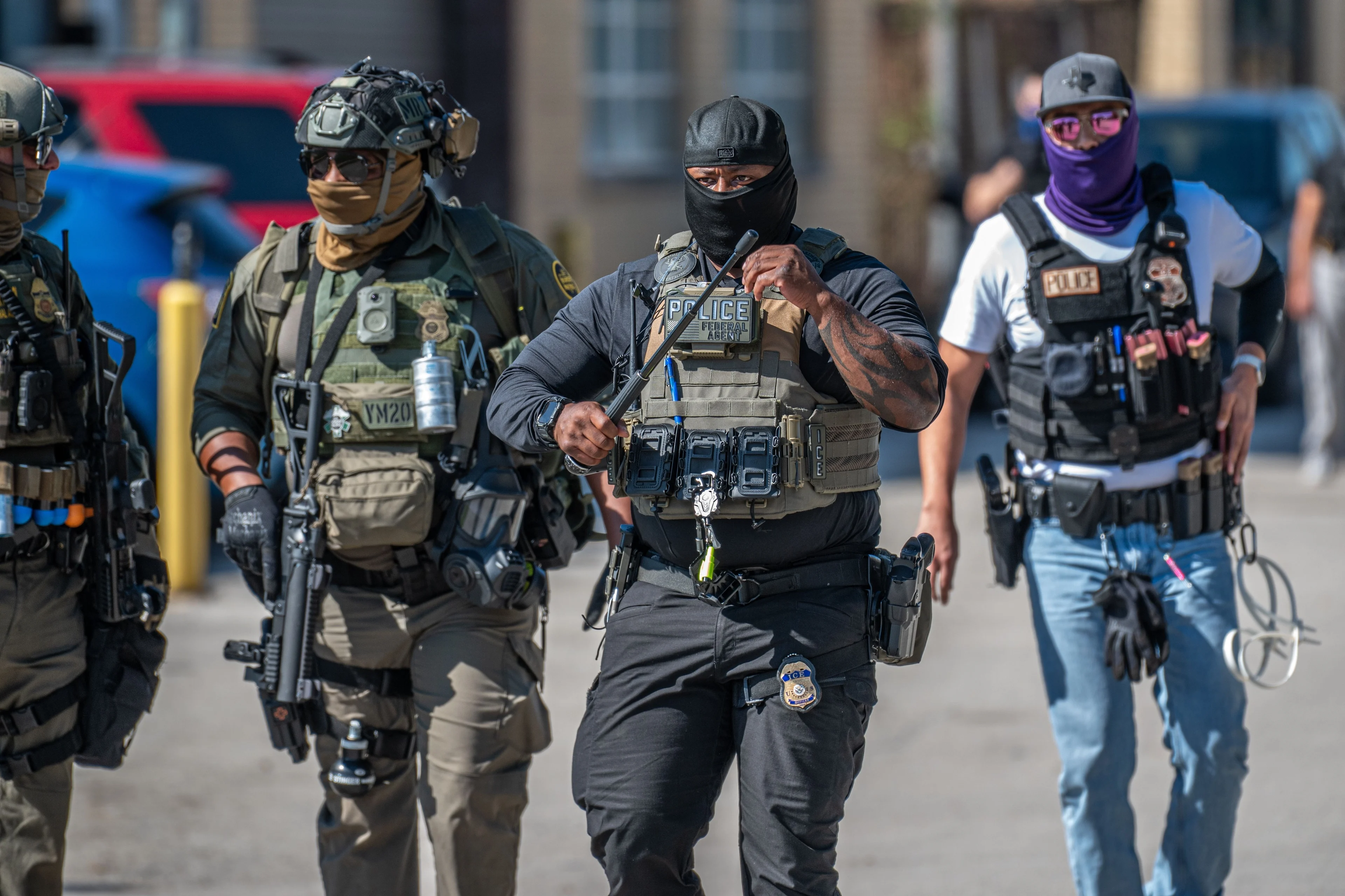 Three men in police gear walking