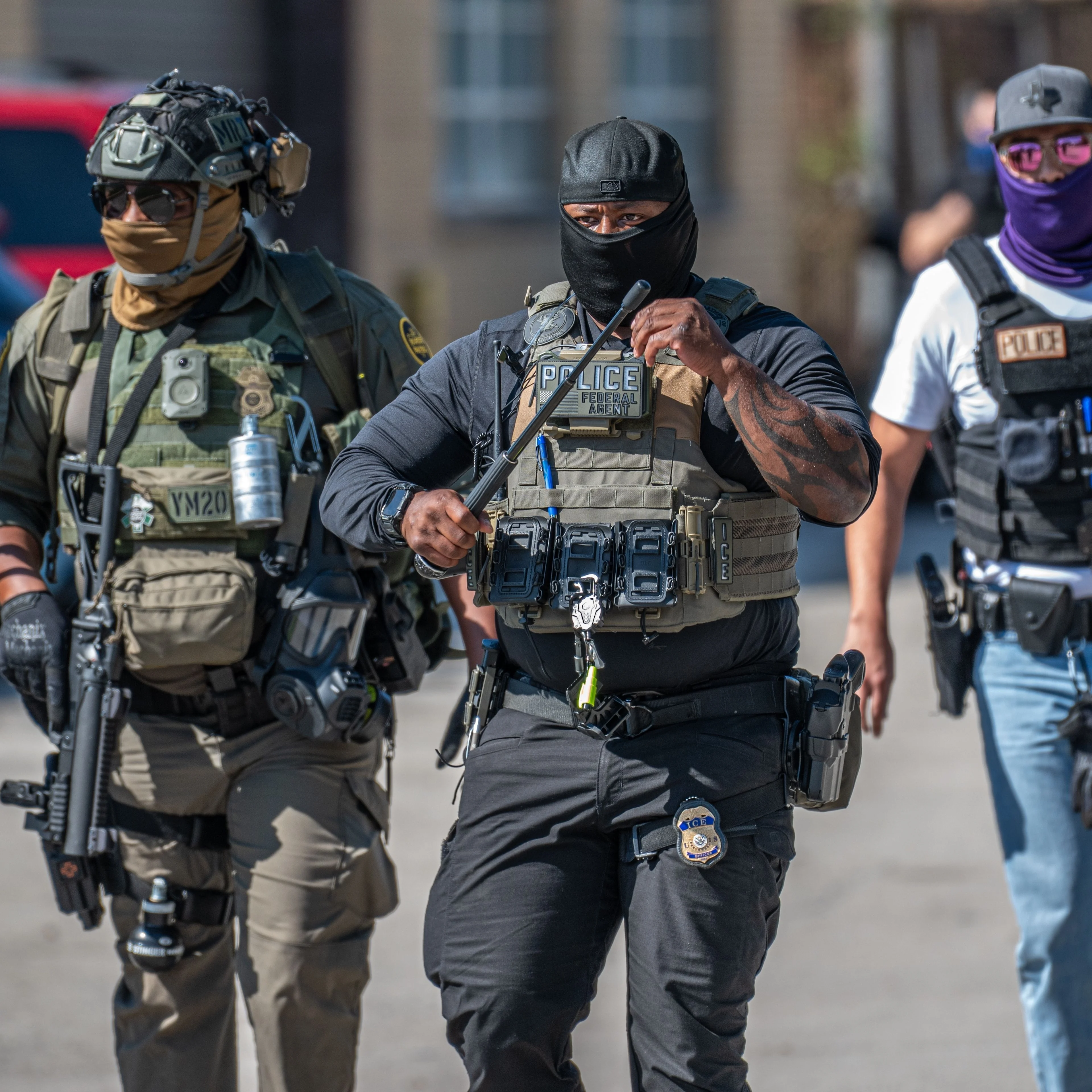 Three men in police gear walking