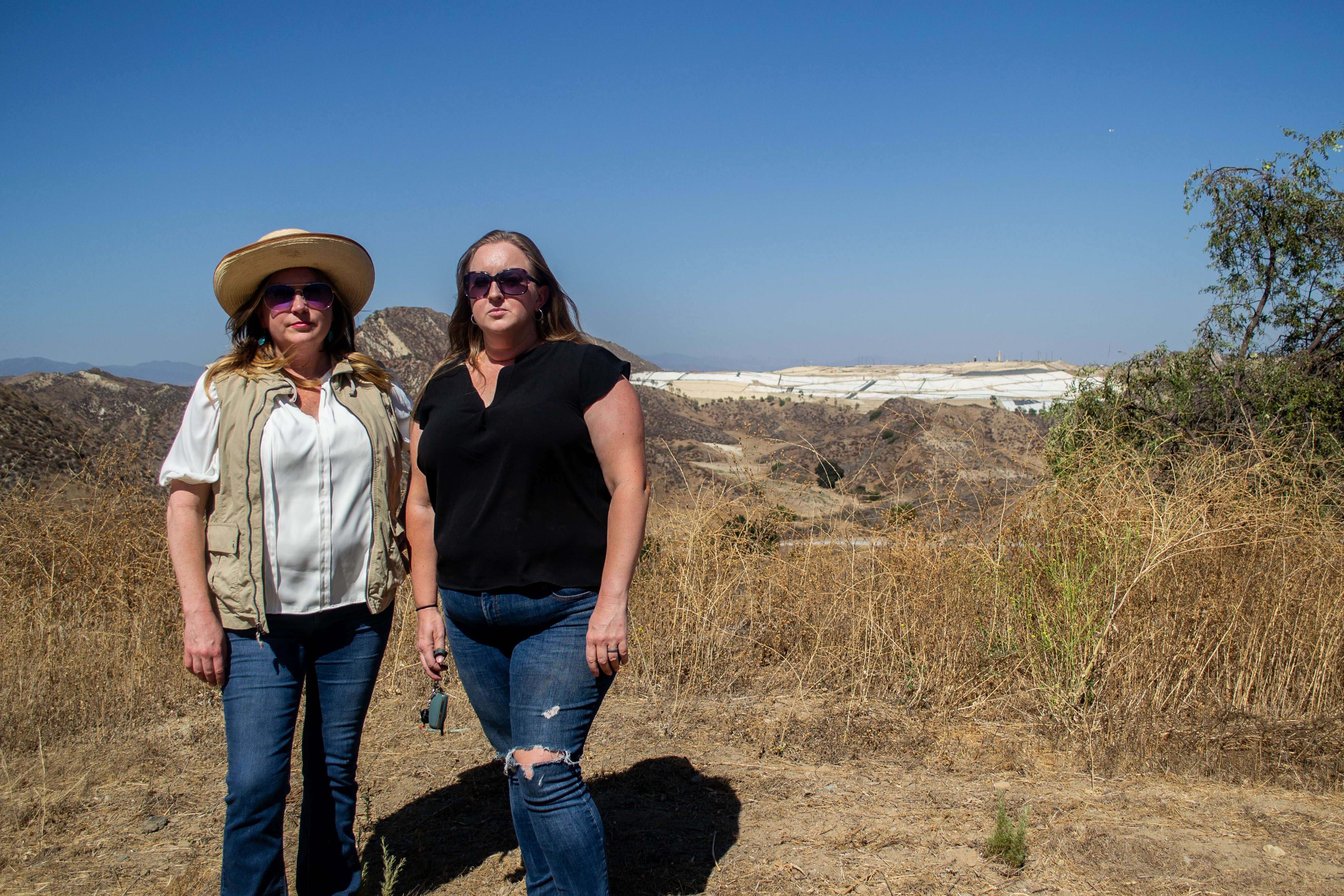Two Val Verde residents stand in front of the Chiquita Canyon Landfill