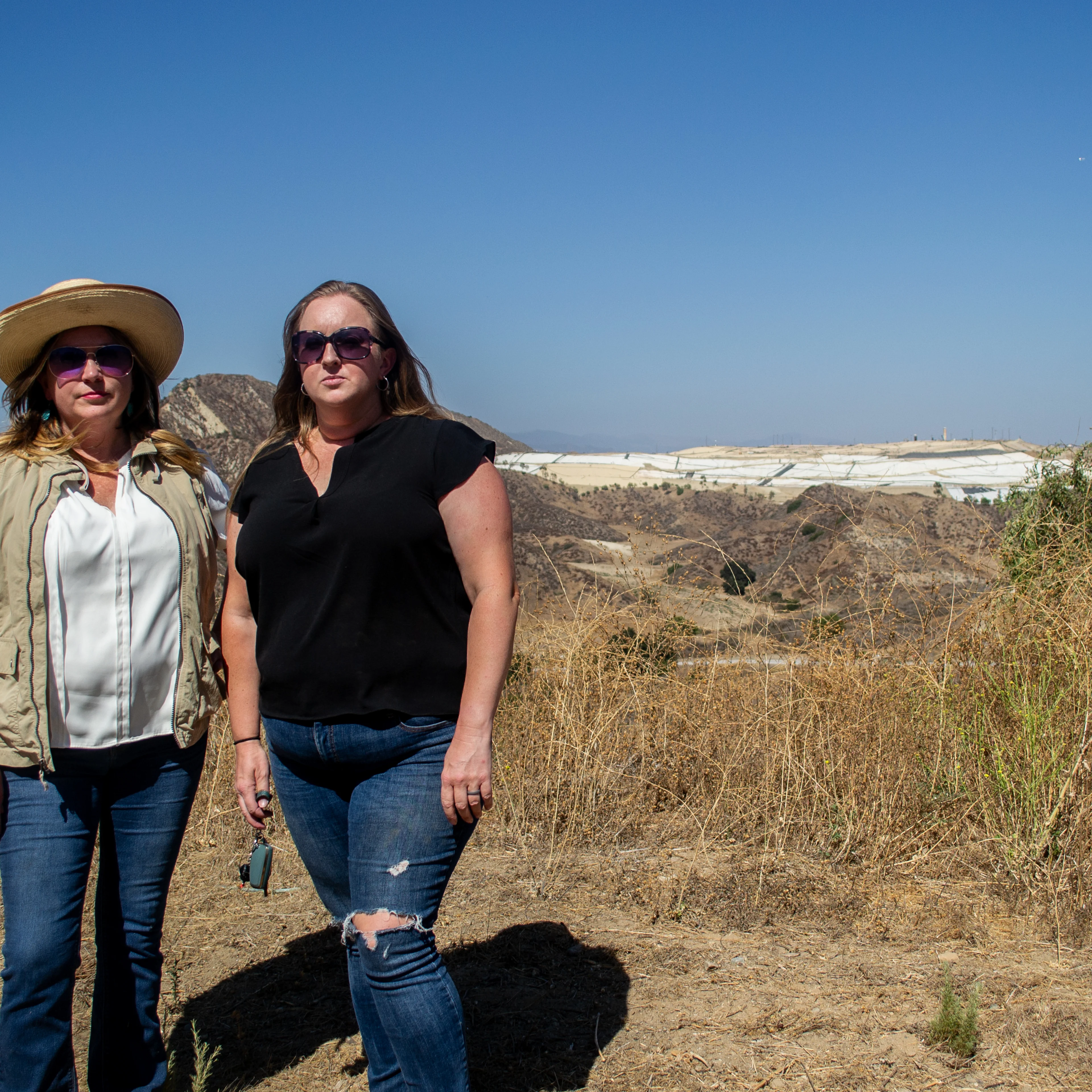 Two Val Verde residents stand in front of the Chiquita Canyon Landfill