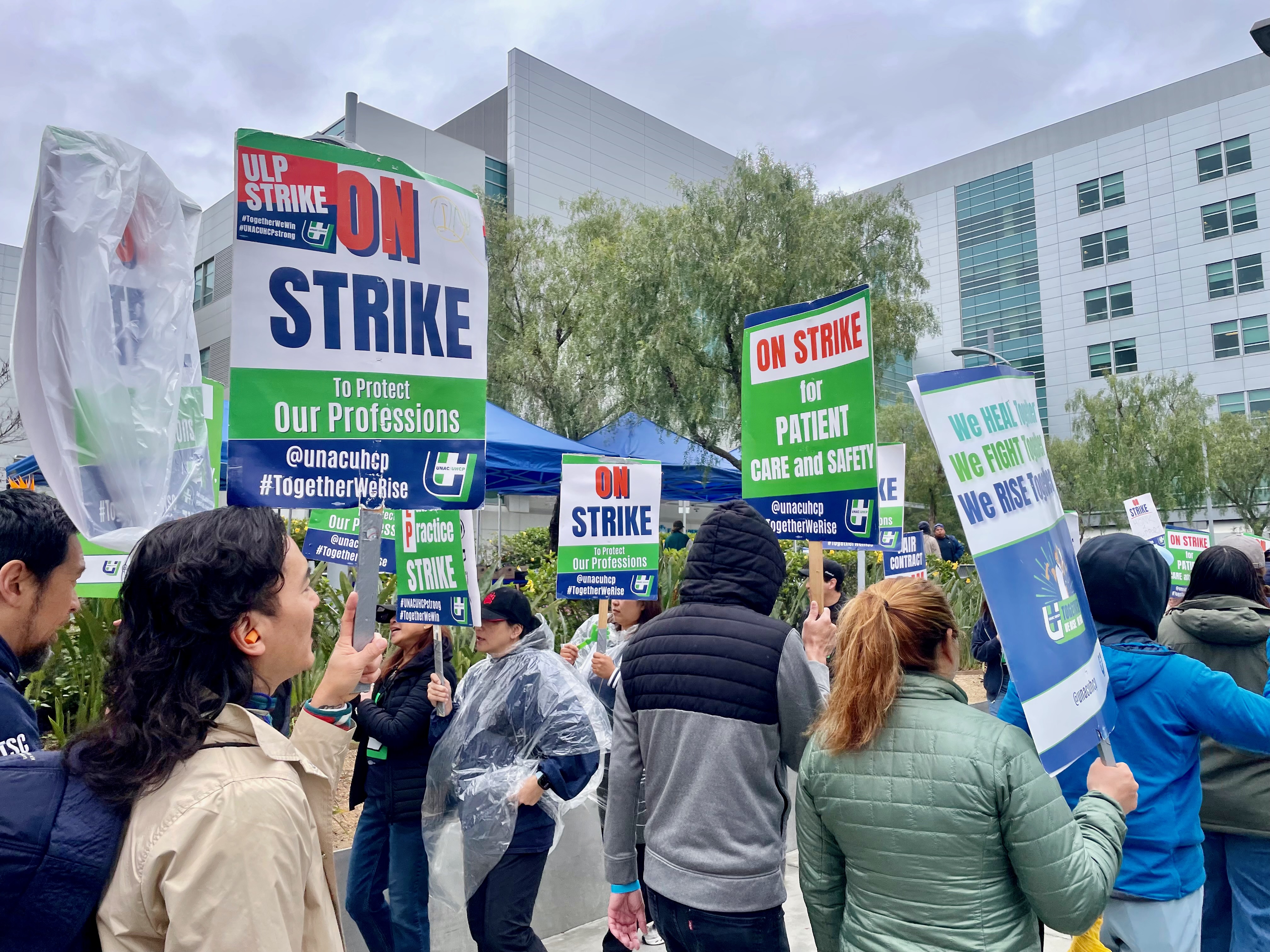 People walk a picket line with signs