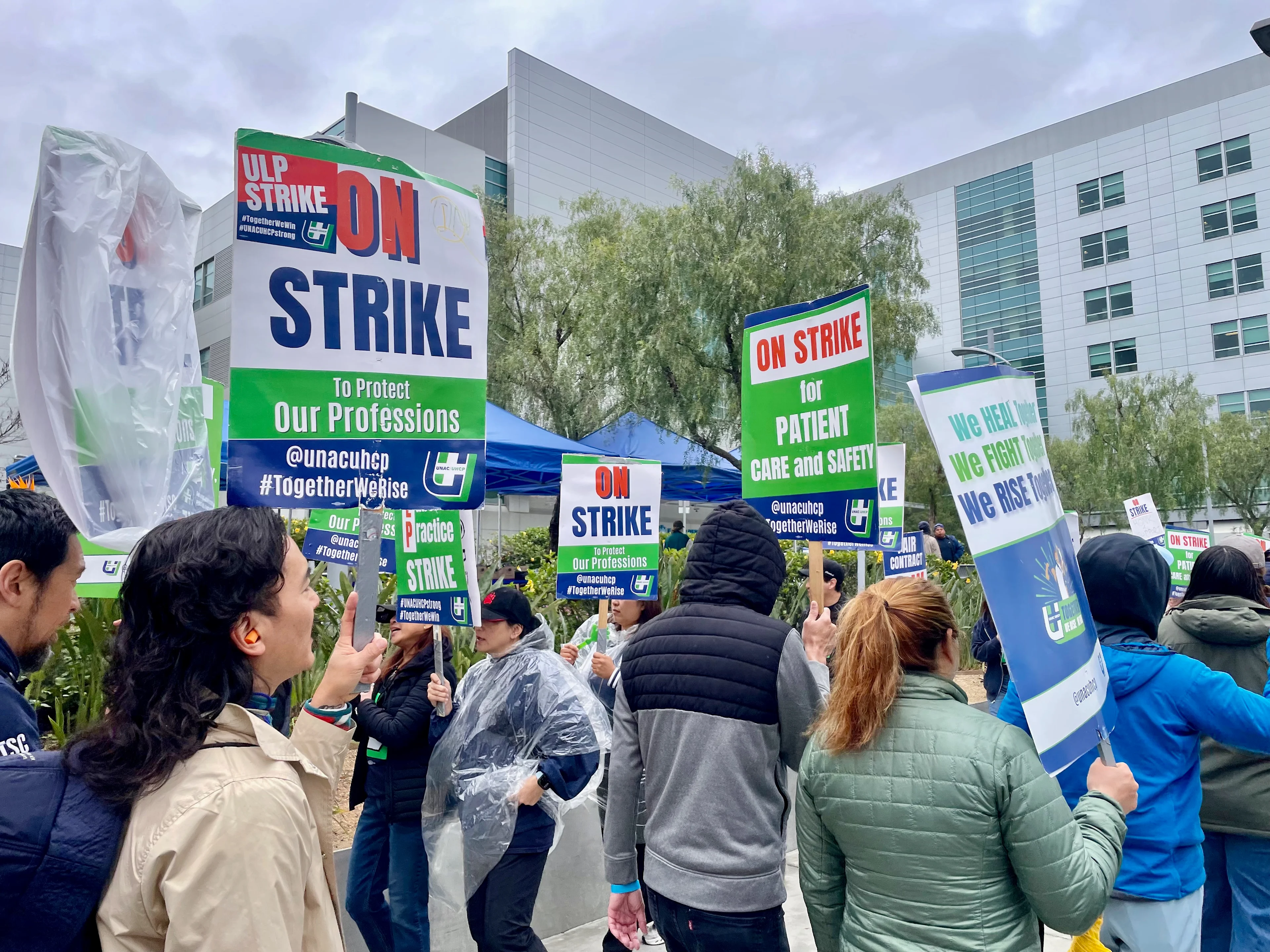 People walk a picket line with signs