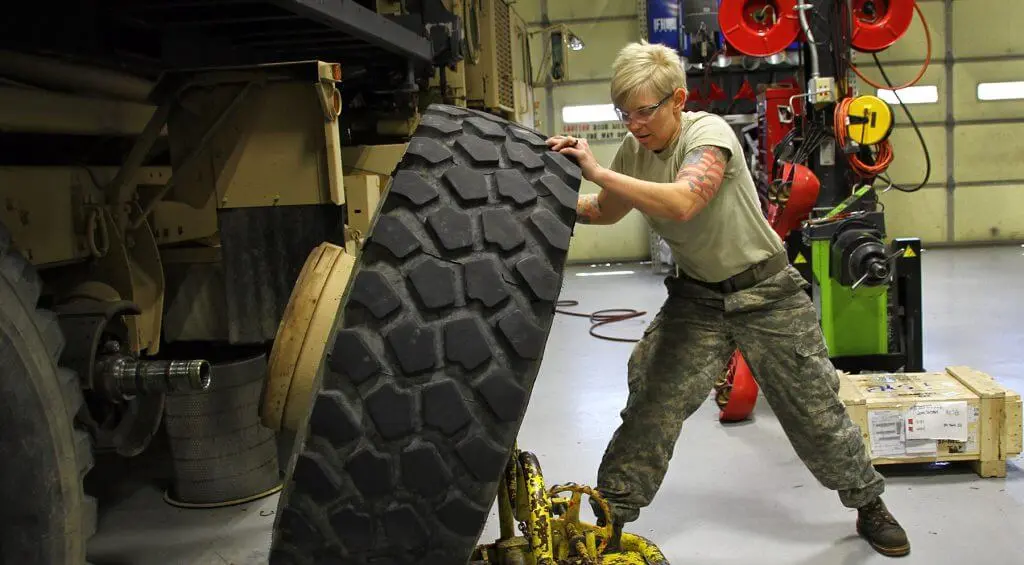 Women in CAD- women lifting tire-e1582813999380-1024x565