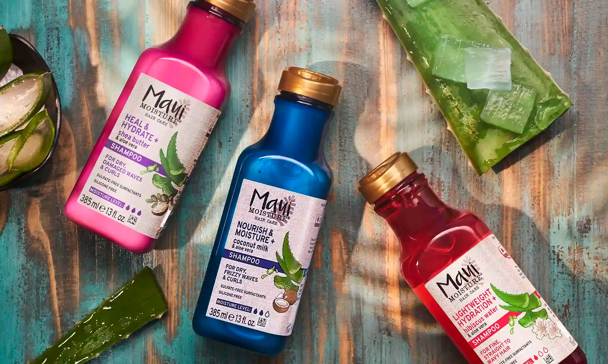 Maui Moisture® Shampoo products surrounded by aloe leaves