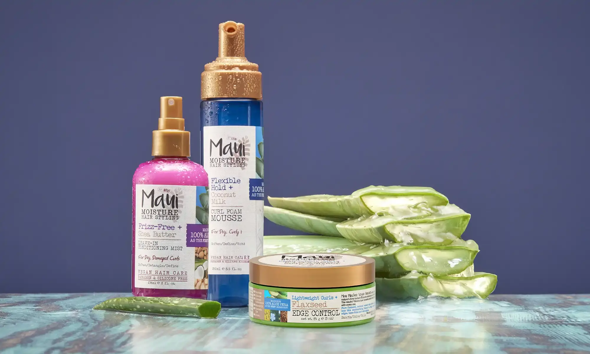 Maui Moisture® hair styler next to aloe leaves