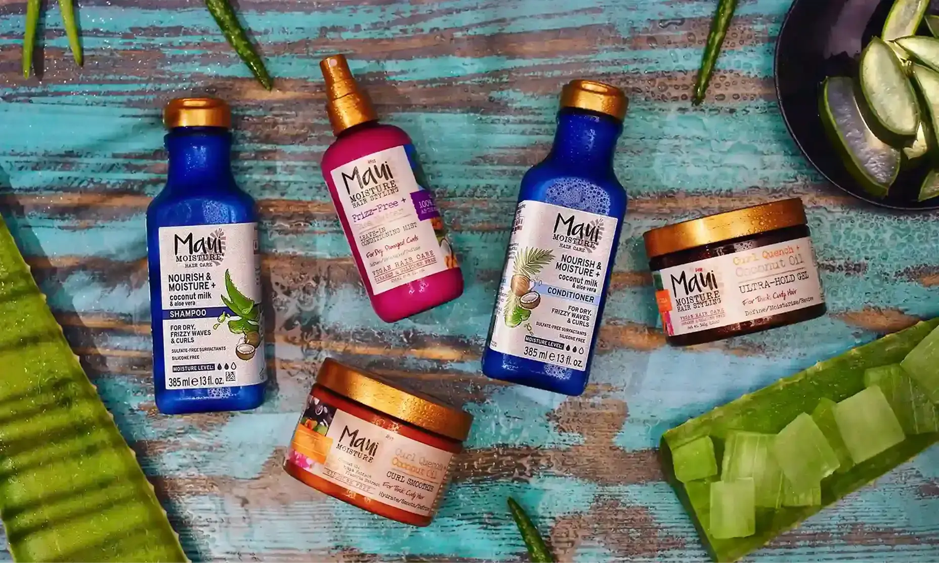 Maui Moisture® shampoo, conditioner and treatment products surrounded by aloe leaves