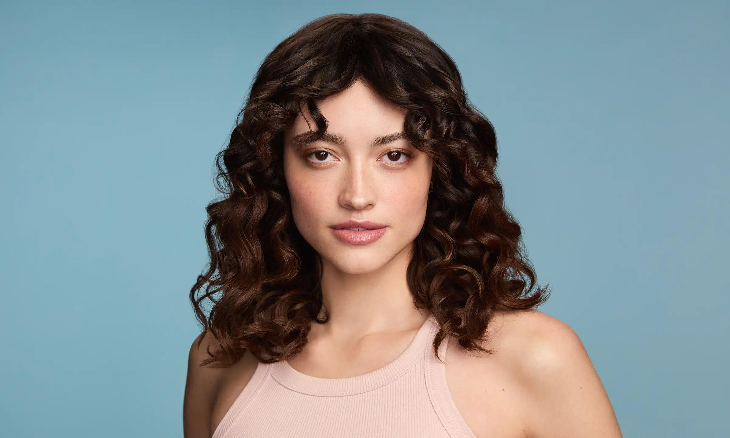 Woman with healthy hair after using Maui Moisture products