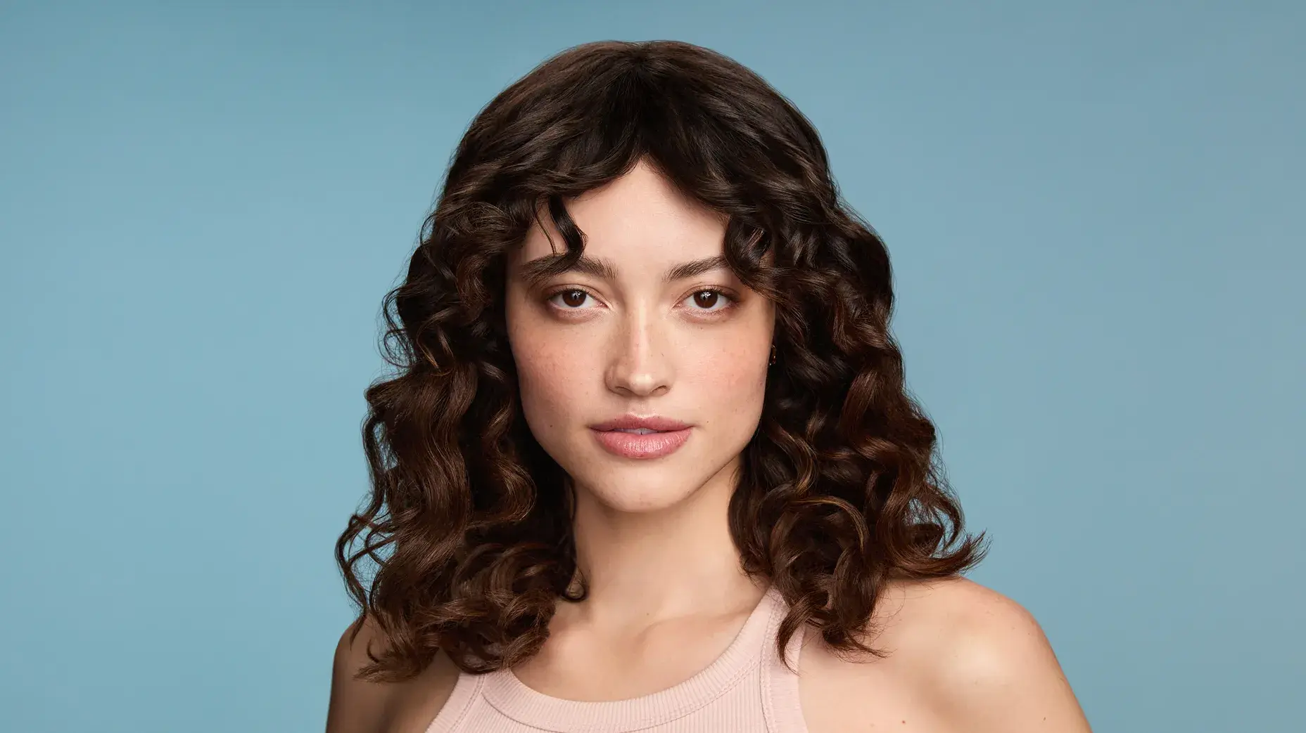 Woman with straight and wavy hair after using Maui Moisture® Products