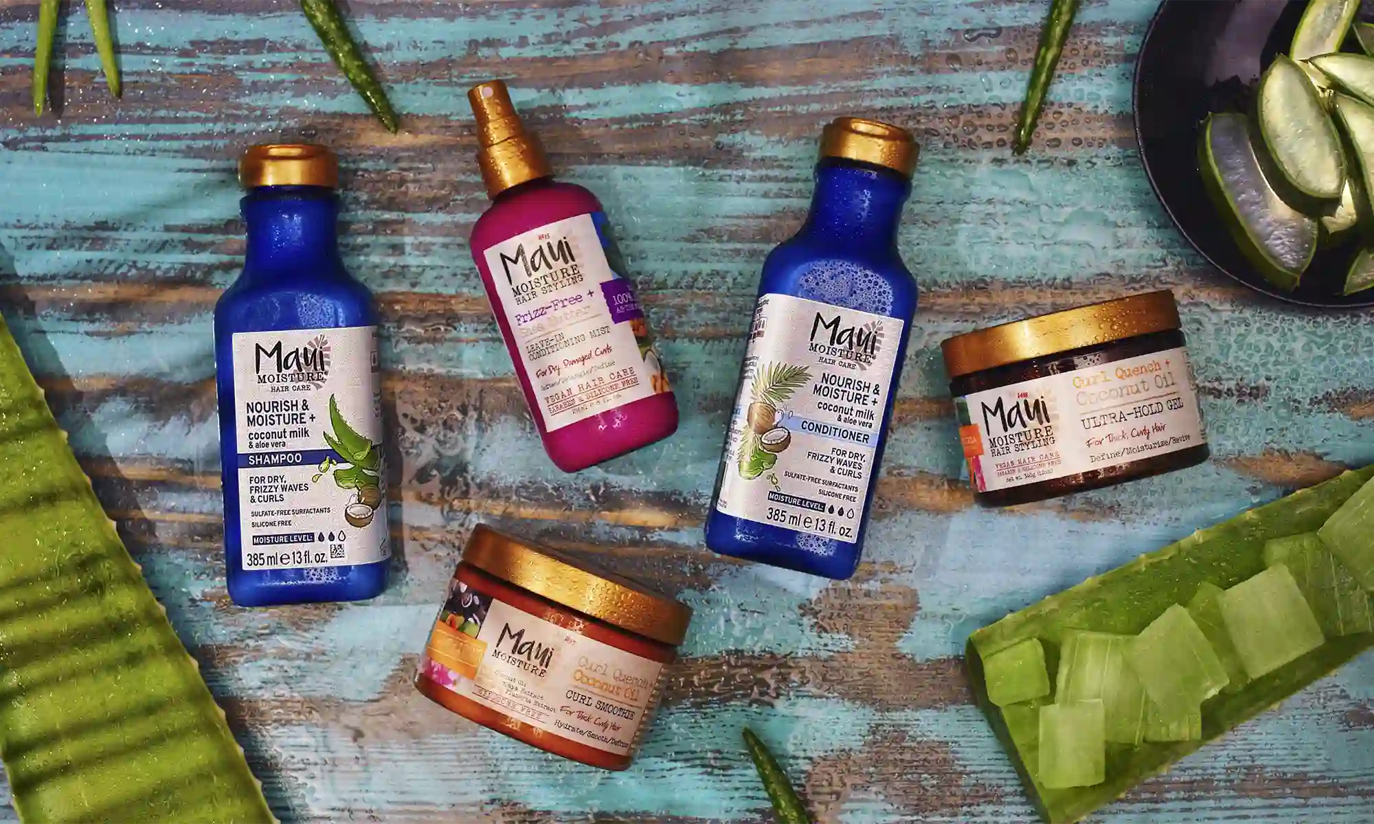 Maui Moisture® shampoo, conditioner and treatment products surrounded by aloe leaves