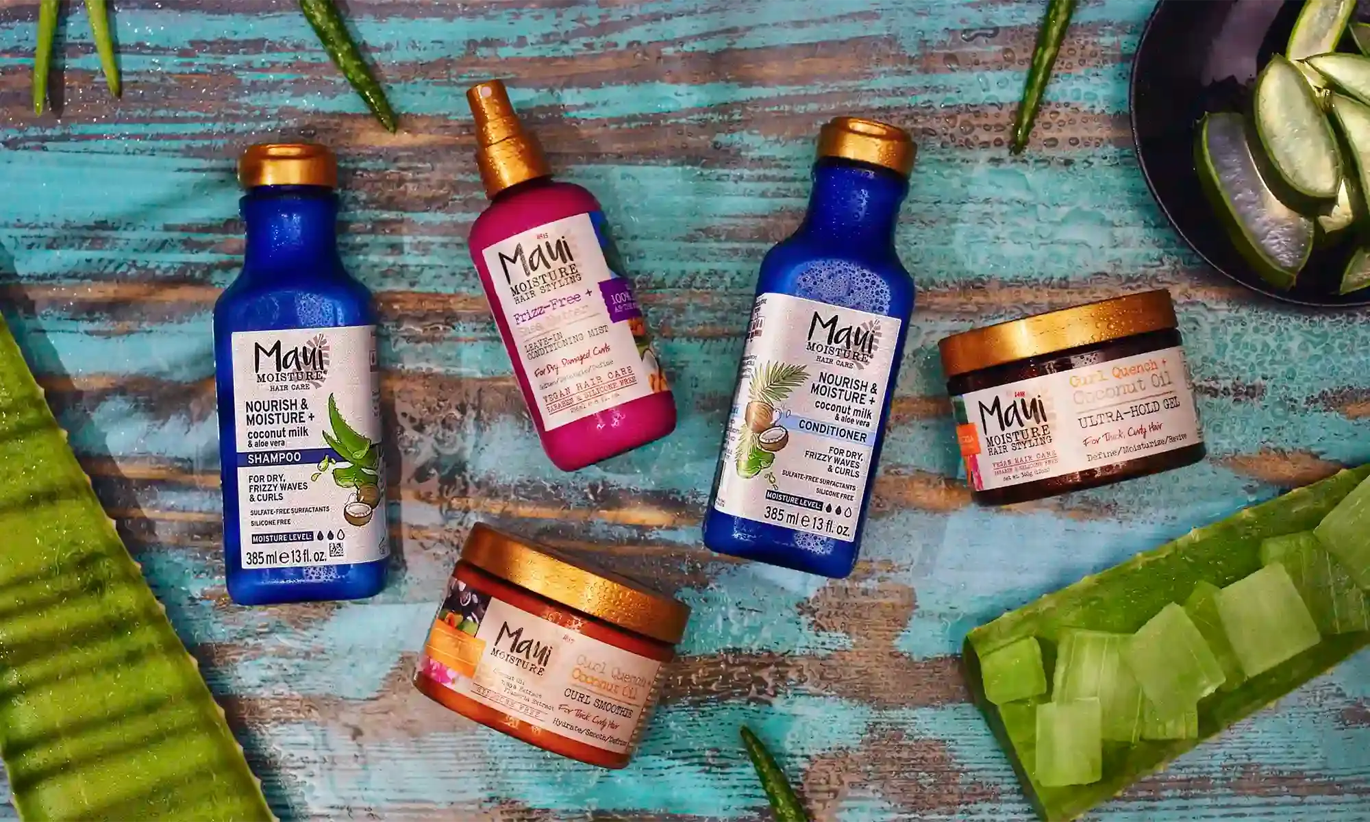 Maui Moisture® shampoo, conditioner and treatment products surrounded by aloe leaves