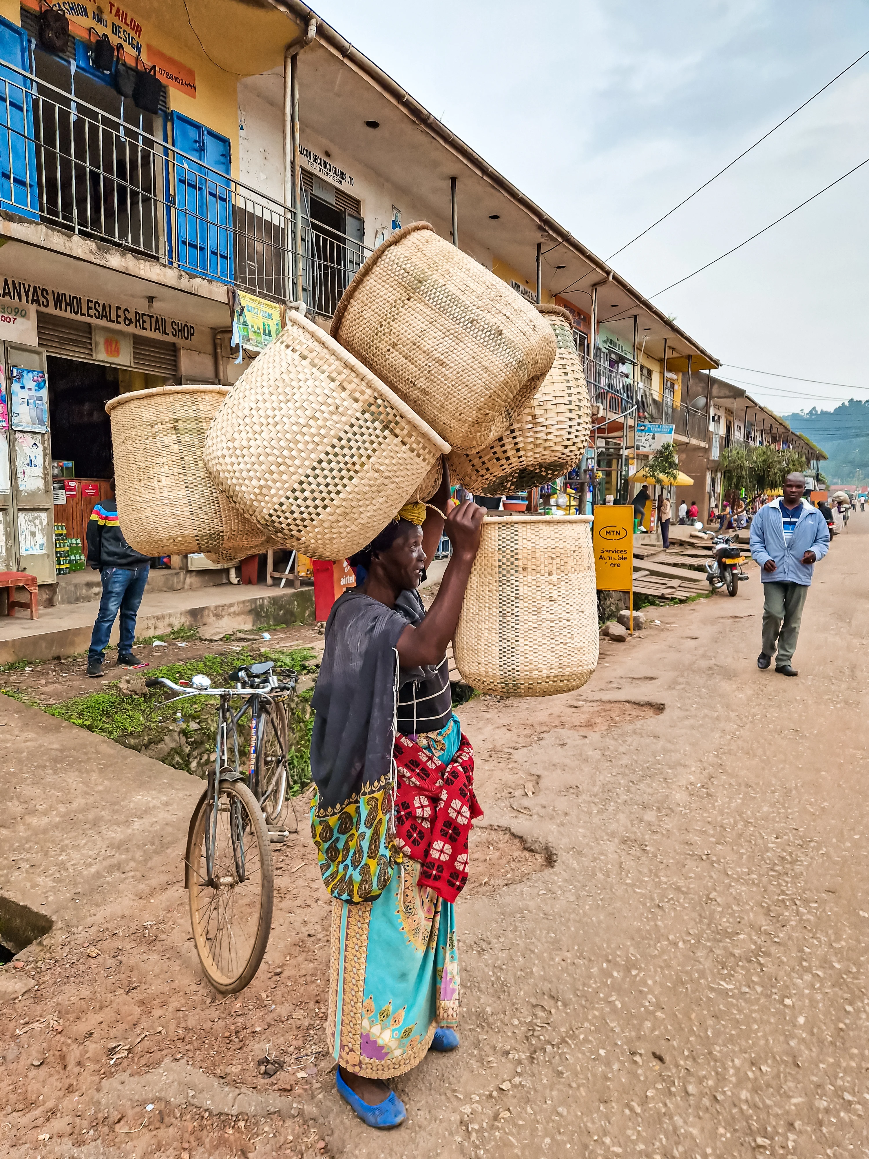 Woman carrying baskets to sell them on the market in Kisoro