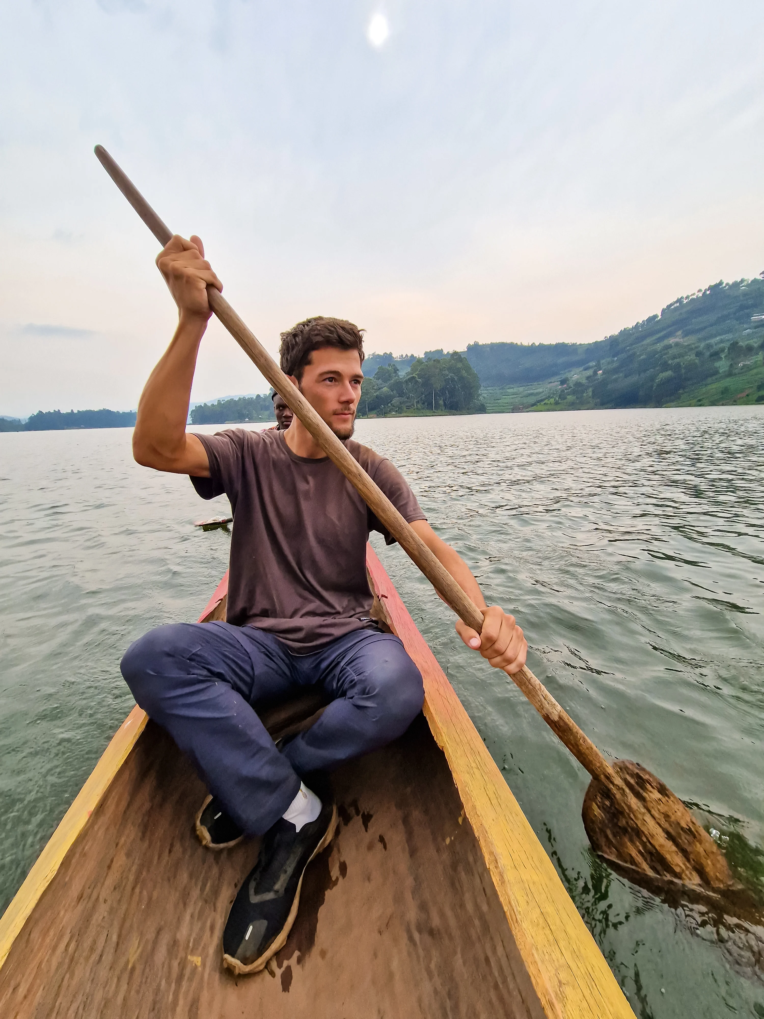 Pol paddling in a authentic canoe on Lake Bunyonyi