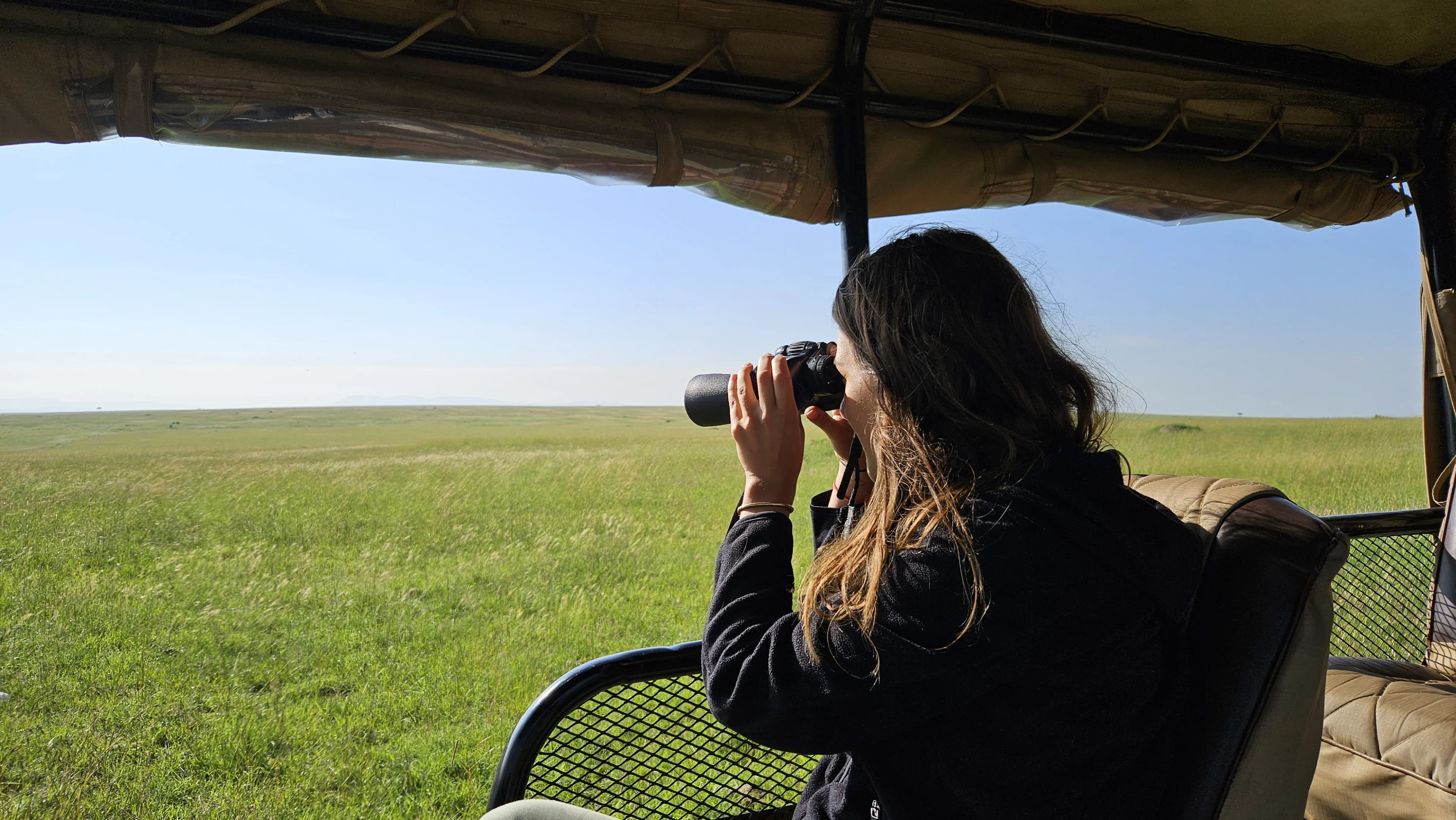 Observing the animals from our open car, with binoculars