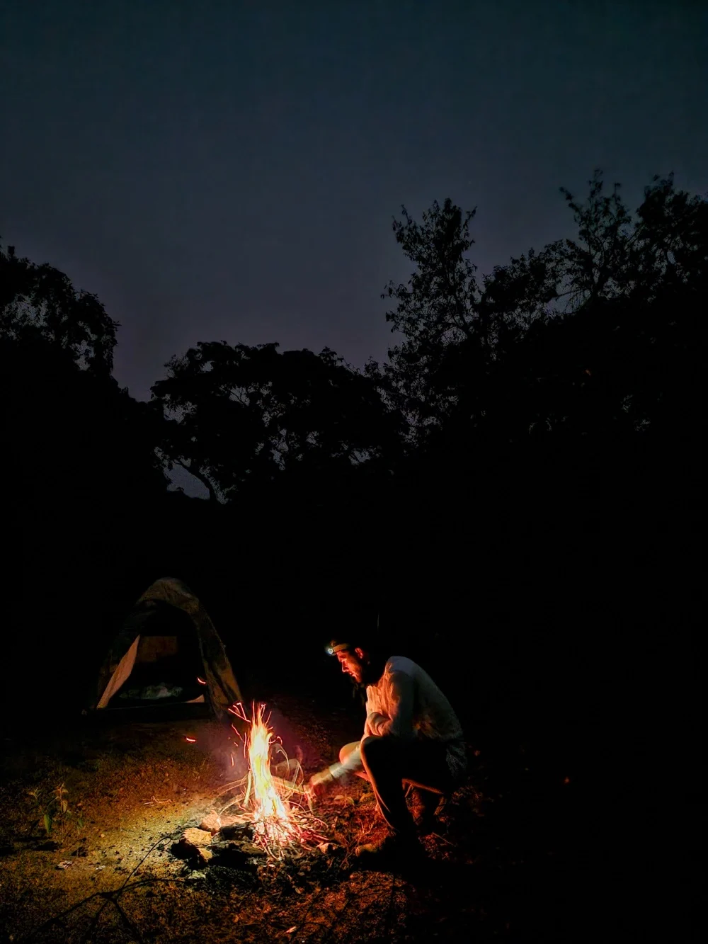 Pol is in charge of making the fire at the Top of the Falls camping site in Murchinson Falls