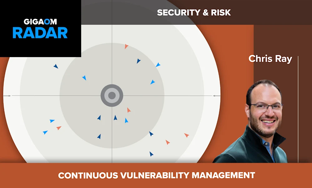 The image shows a slide about "Continuous Vulnerability Management" from a presentation titled "Security & Risk". The slide displays a radar chart with blue and red triangular markers representing security risks or vulnerabilities.

In the bottom right corner, there is a photo of a smiling man with glasses and a blue collared shirt, identified as Chris Ray according to the text below his picture. The overall color scheme consists of shades of orange and brown.