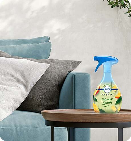Bottle of Fabric Mango Splash sitting on a living room side table.
