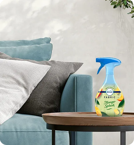 Bottle of Fabric Mango Splash sitting on a living room side table.