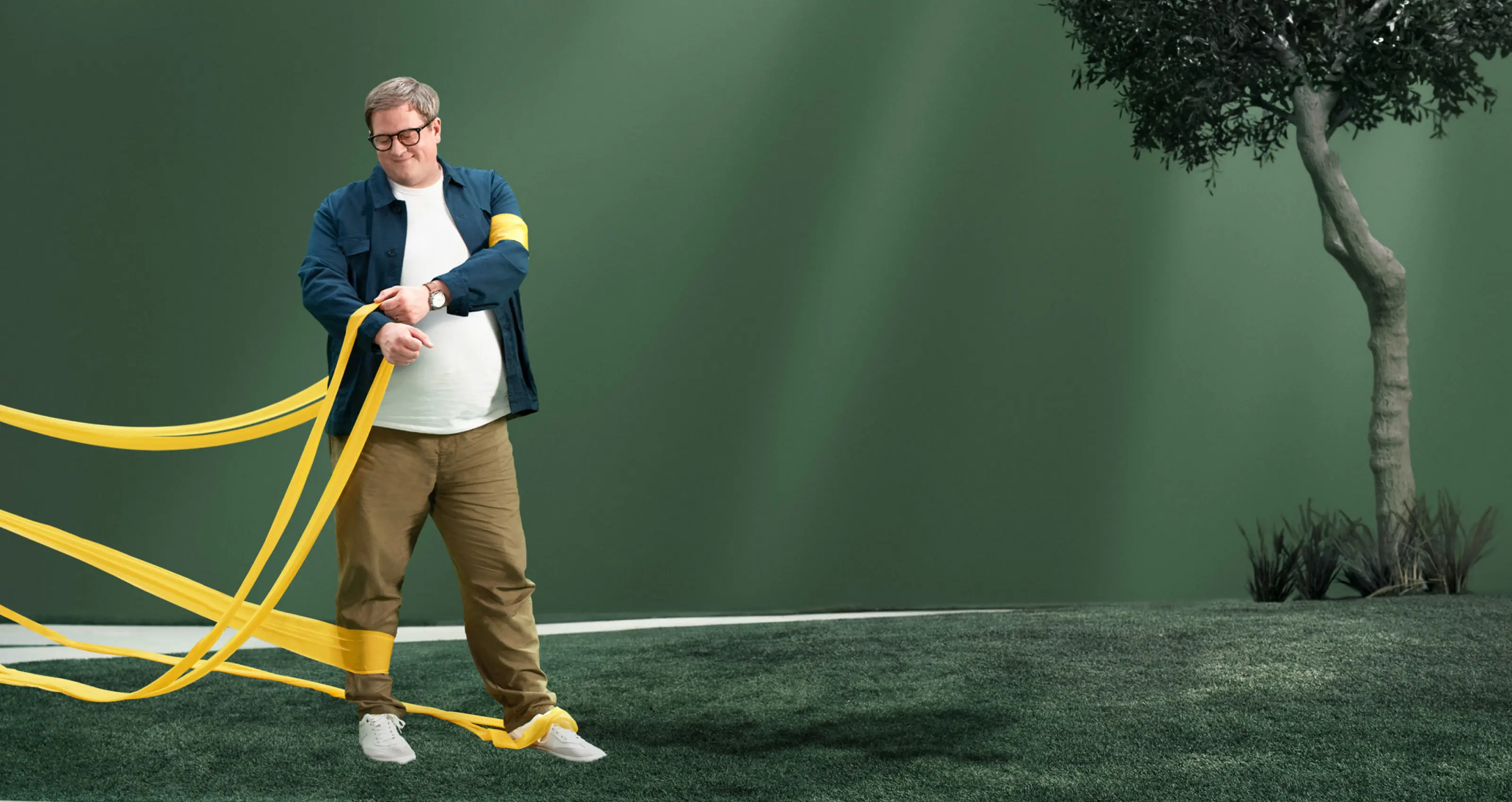 Man with obesity, removing a slack resistance band while others remain around him