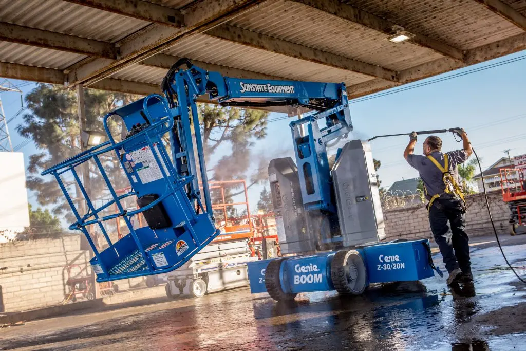 Person washing an articulating boom lift