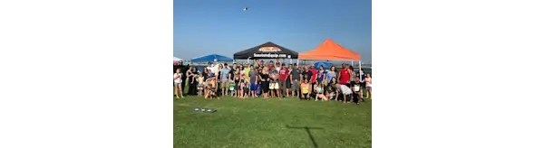 People standing outside in front of shade tents at the Sunstate Employee Appreciation Event