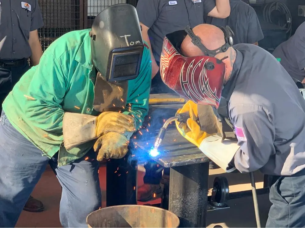 Two people welding