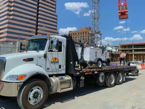 A Sunstate truck delivering equipment to a construction jobsite in Balch Springs, TX.