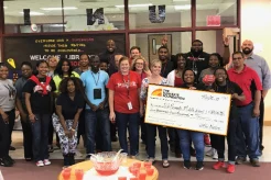 Large check donated by DFW Metro branch to a local middle school