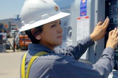 A woman working on construction equipment