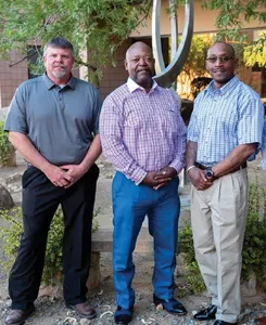 Three men standing together