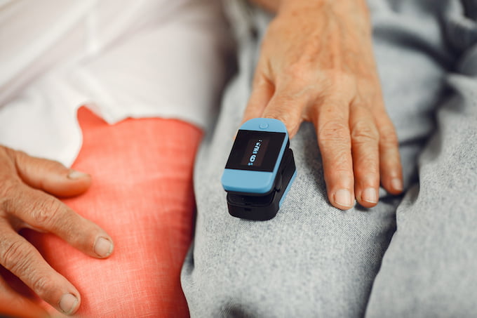 doctor-puts-heart-rate-monitor-patient-finger-man-holds-woman-s-hand-1-2