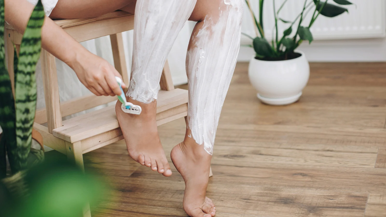 Woman shaving her leg on dry skin