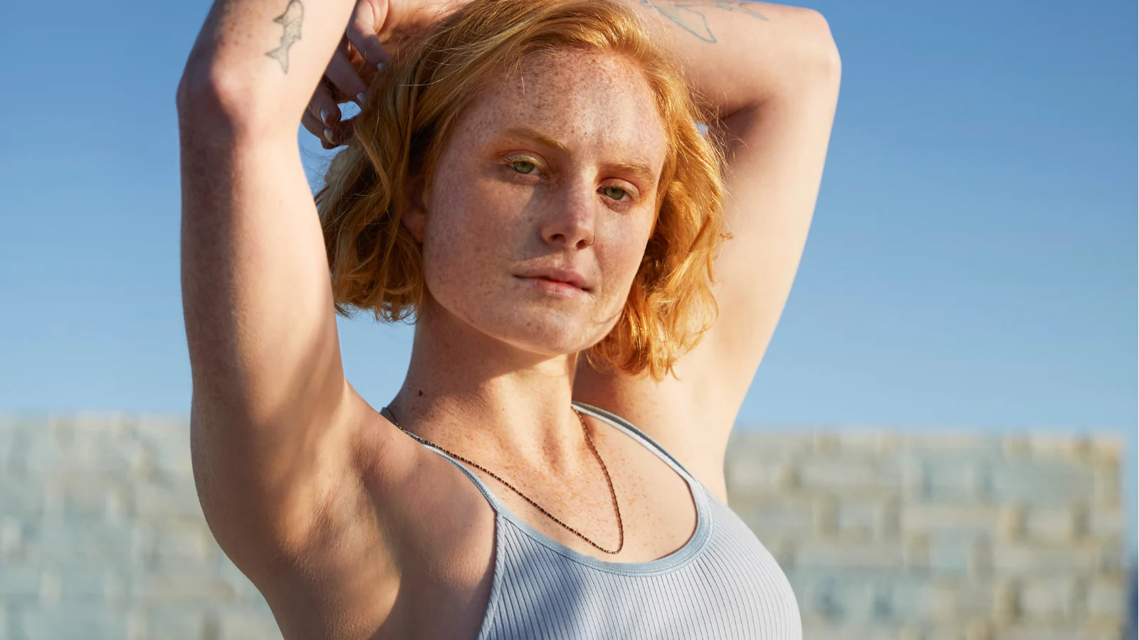 Woman Standing Under the Sky Showing Her Armpits