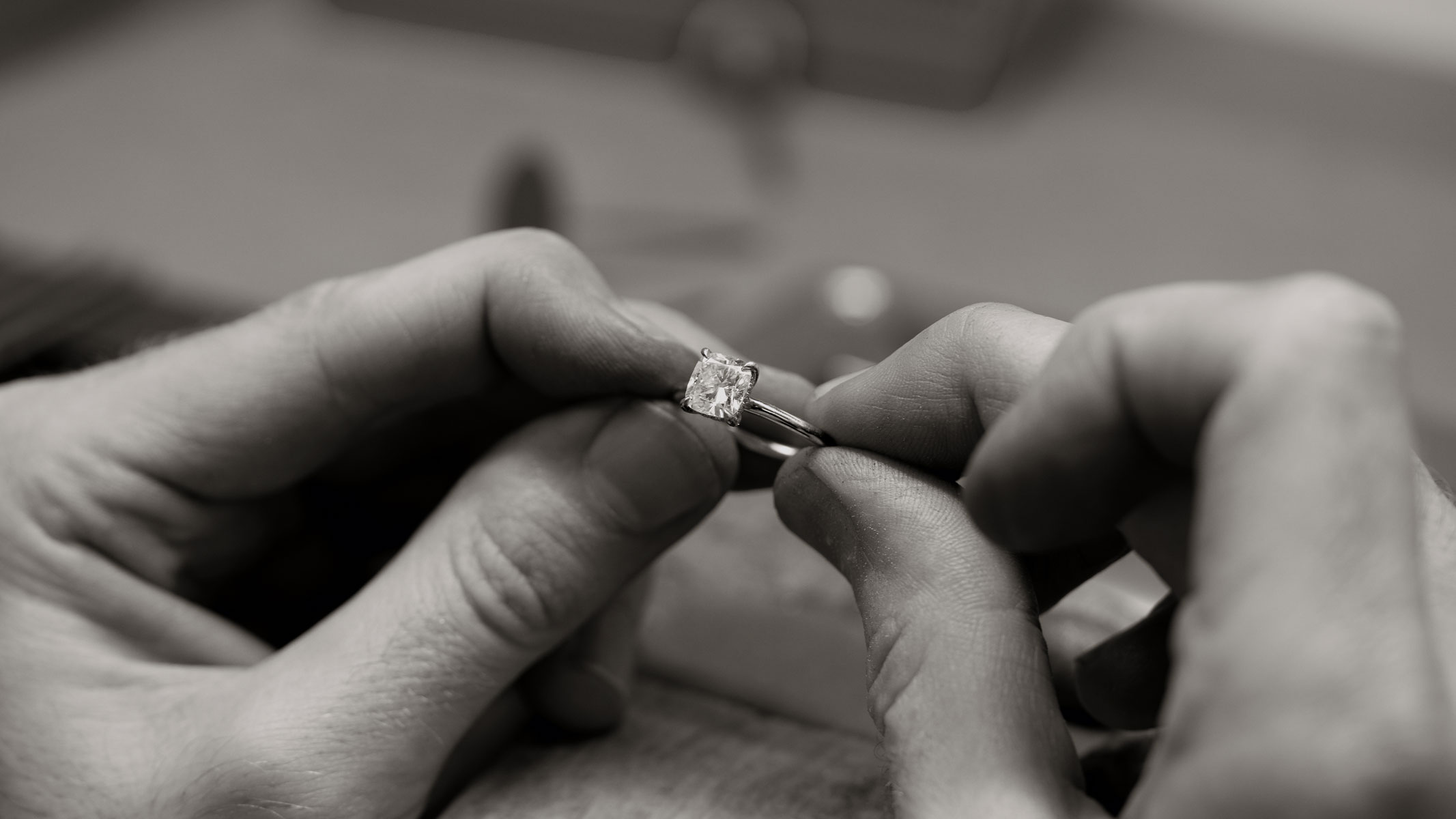 image taken from behind of a woman holding hear hair, wearing diamond rings