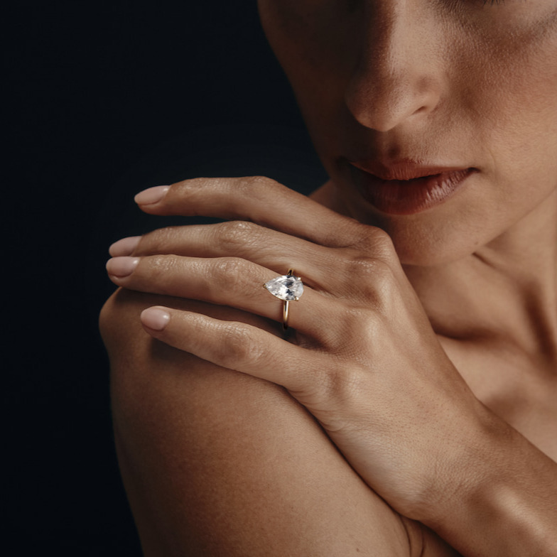 A woman with a pear shaped diamond engagement ring