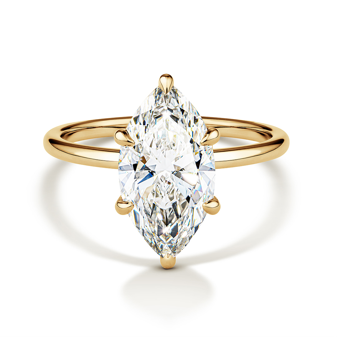 fine gold ring with a marquise diamond on a white background