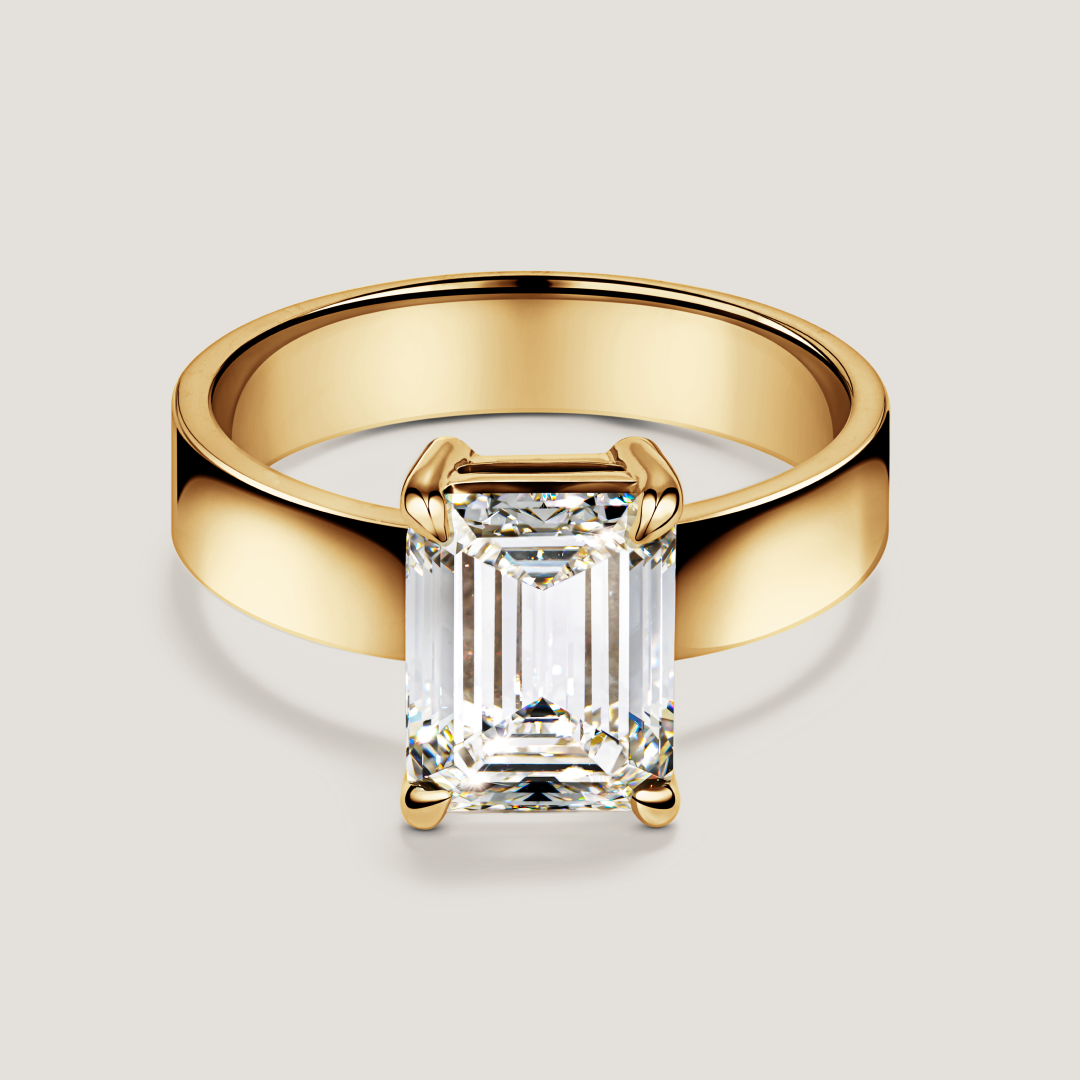 Gold ring with a single large emerald-shaped diamond