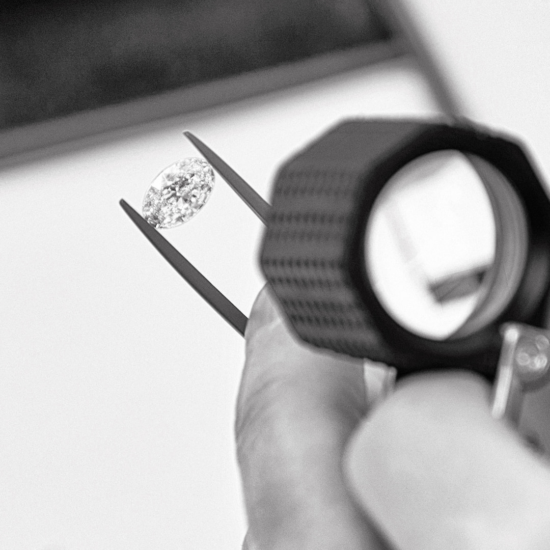 a diamond being inspected using a jeweller's loupe