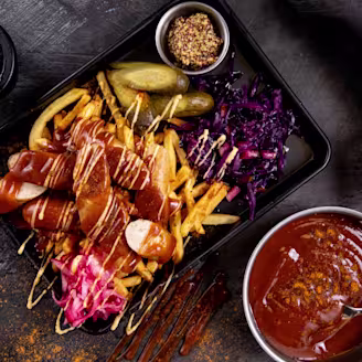 Tray of food including Quorn, fries, gherkins and cabbage
