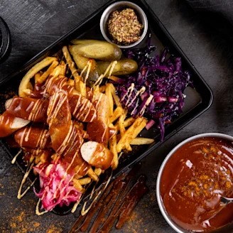 Tray of food including Quorn, fries, gherkins and cabbage