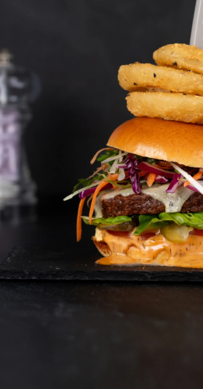 Quorn burger with onion rings on top