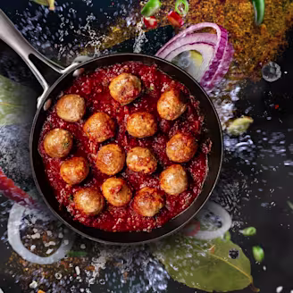 Pan of Quorn Swedish Style Meatballs in a tomato sauce