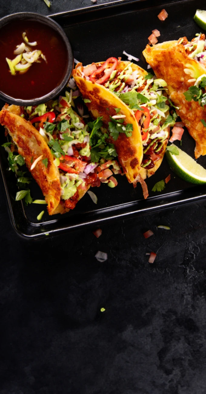 Quorn Tacos with a sauce on a tray