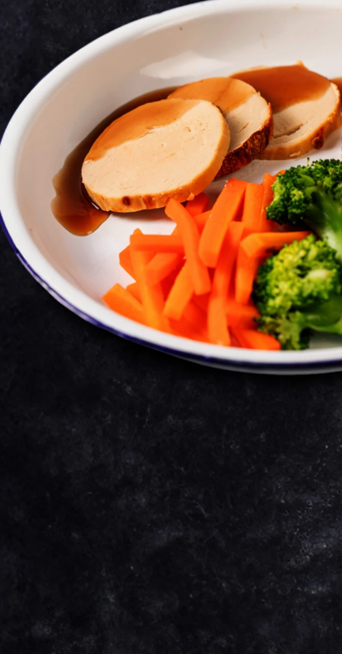 A plate of food containing Quorn, broccoli, carrots and potatoes