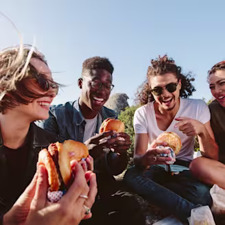 Group of students enjoying Quorn burgers at an outdoor picnic