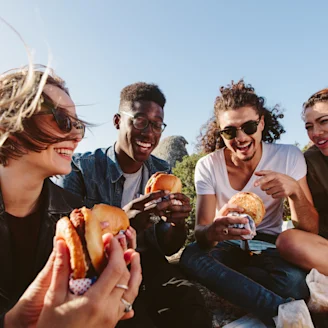 Group of students enjoying Quorn burgers at an outdoor picnic