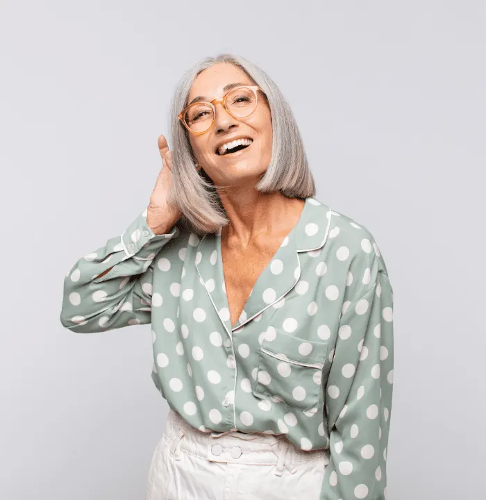 A Happy Women embracing her healthy silver hair